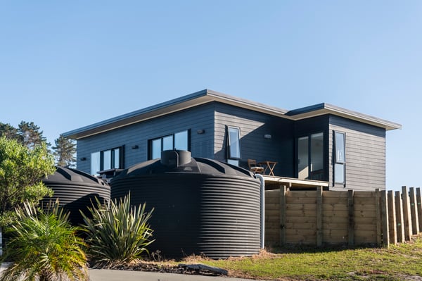 Promax Rainwater tanks installed outside of a home